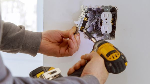 Electrician installing residential outlet